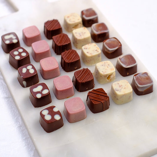 chocolate square bites on a marble plate